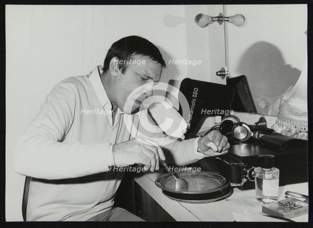 Buddy Rich eating backstage at Ronnie Scott's Jazz Club, London, 1979. Creator: Denis Williams.