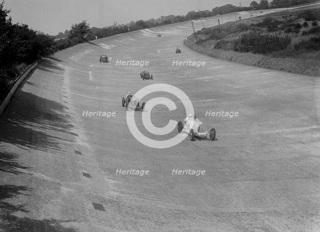 Bugatti T37s of Eileen Ellison and S Smith on Byfleet Banking, BARC meeting, Brooklands, 1933. Artist: Bill Brunell.