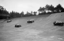Bugatti Type 43, Sunbeam and Invicta racing on the Members Banking at Brooklands. Artist: Bill Brunell
