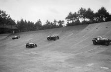 Bugatti Type 43, Sunbeam and Invicta racing on the Members Banking at Brooklands. Artist: Bill Brunell