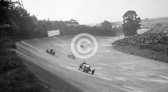 Bugatti Type 54 leading a Talbot 90 on the banking at Brooklands, 1930s. Artist: Bill Brunell.