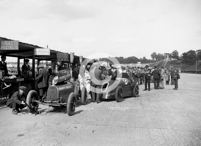 Bugatti Special 1 and Gwynne Special in the pits at a BARC meeting, Brooklands, 1933. Artist: Bill Brunell.