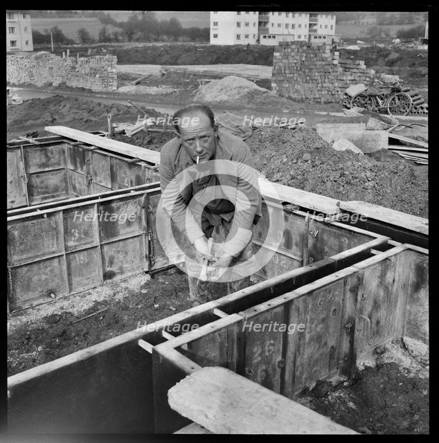 Builder working on the Penhill Estate, Swindon, Wiltshire, 1955. Creator: Unknown.
