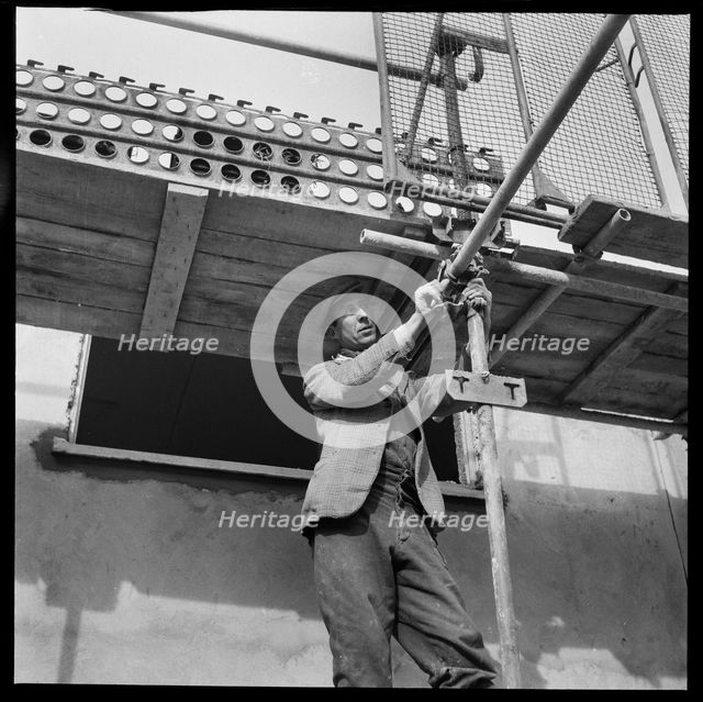 Builder working on the Penhill Estate, Swindon, Wiltshire, 1955. Creator: Unknown.