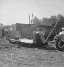 Building an auto trailer in a squatter camp, Outskirts of Bakersfield, California, 1936. Creator: Dorothea Lange