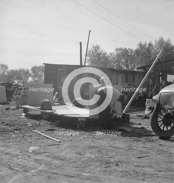 Building an auto trailer in a squatter camp, Outskirts of Bakersfield, California, 1936. Creator: Dorothea Lange.