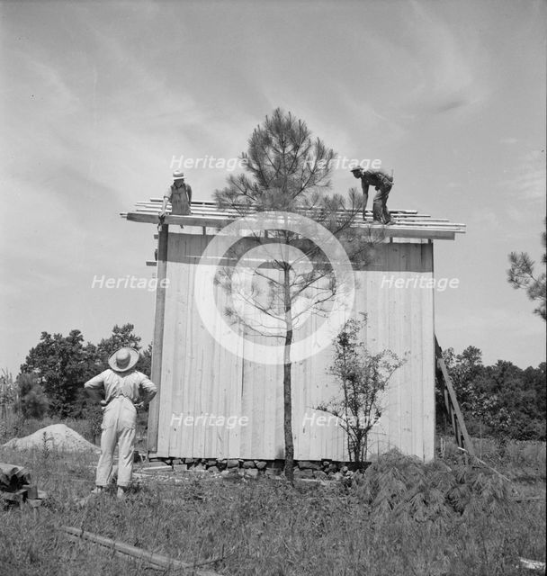 Building plank tobacco barn to replace old log one, near Chapel Hill, North Carolina, 1939 Creator: Dorothea Lange.