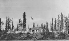 Building with American flag raised, between c1900 and 1916. Creator: Unknown
