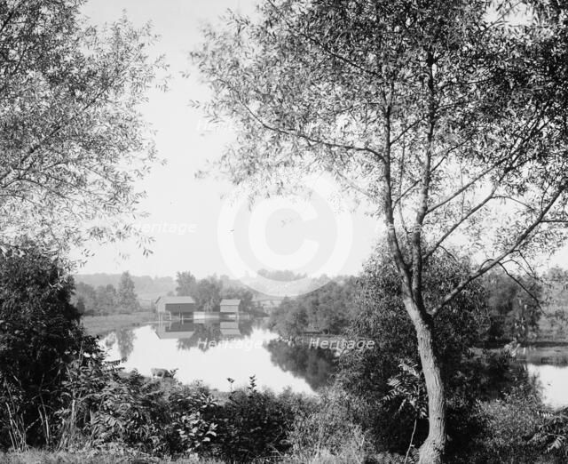 Buildings by river, probably the Huron River, Ypsilanti, Michigan, between 1900 and 1910. Creator: Unknown.