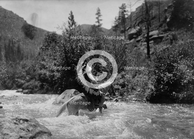 Bullchief at the ford, c1905. Creator: Edward Sheriff Curtis.