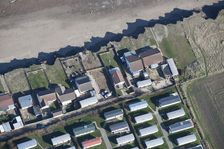 Bungalows at risk from coastal erosion, Green Lane, near Skipsea, East Riding of Yorkshire, 2014. Creator: Historic England Staff Photographer