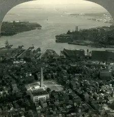 Bunker Hill Monument and Boston Harbor from the Air, Boston, Mass. c1930s. Creator: Unknown