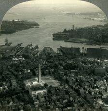 Bunker Hill Monument and Boston Harbor from the Air, Boston, Mass. c1930s. Creator: Unknown