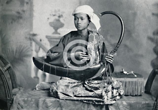 Burmese harp player, 1902. Artist: Unknown.