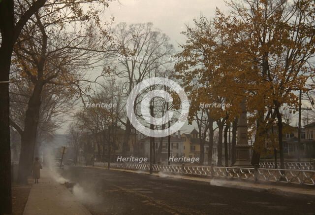 Burning the autumn leaves in Norwich, Connecticut, 1940. Creator: Jack Delano.
