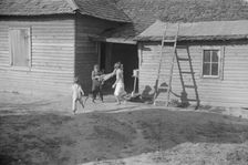 Burroughs children playing in the yard, Hale County, Alabama, 1936. Creator: Walker Evans