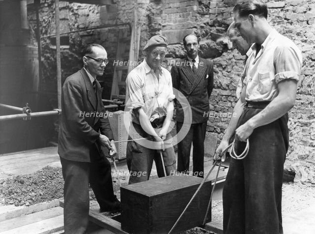 Burying a box containing copies of the "Jewish Chronicle", London, 1955. Creator: Unknown.