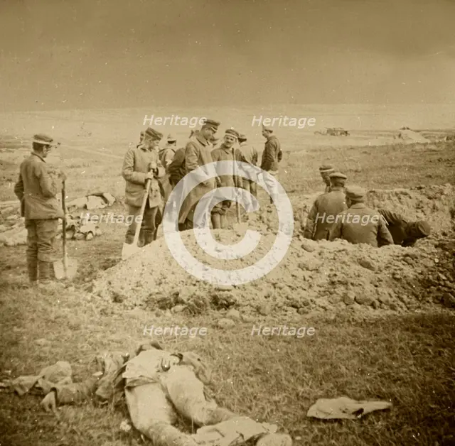 Burying bodies, Sainte-Marie-à-Py, northern France, c1914-c1918.  Artist: Unknown.