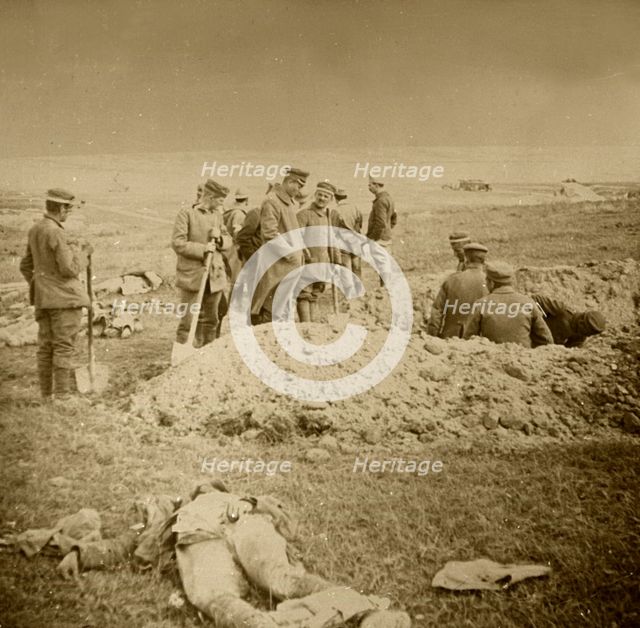 Burying bodies, Sainte-Marie-à-Py, northern France, c1914-c1918.  Artist: Unknown.
