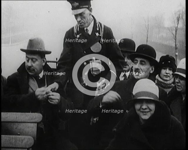 Bus Conductor Collecting Fares on the Open Top of a Bus, 1922. Creator: British Pathe Ltd.