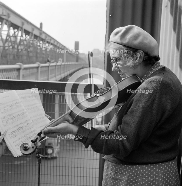 Busker playing the violin, Hungerford Bridge, Lambeth, London, c1946-c1959. Artist: John Gay