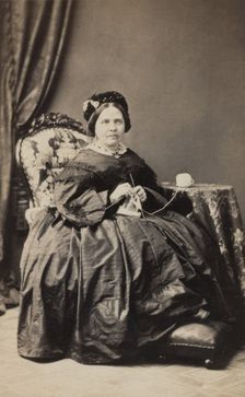 Business card, studio portrait of elderly woman knitting. (c1880s). Creator: Karolina Christianson