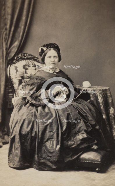 Business card, studio portrait of elderly woman knitting. (c1880s). Creator: Karolina Christianson.