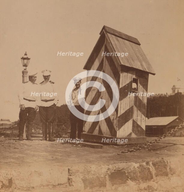 By the railway, three men in uniform standing near a guard booth, Vladivostok, Russia, 1899. Creator: Eleanor Lord Pray.