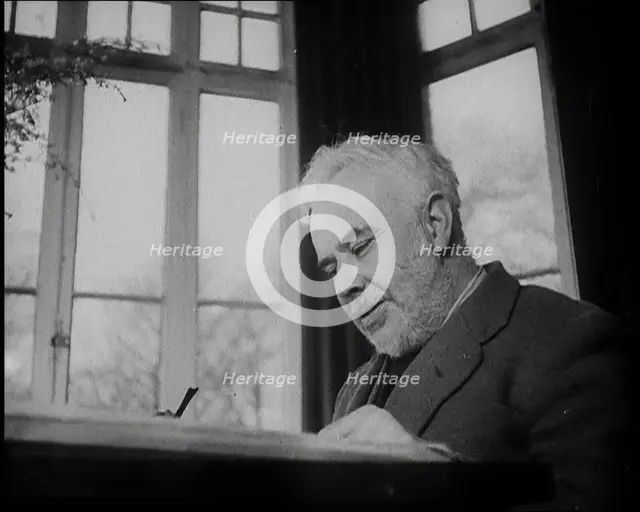 C.E.M Joad Sitting Down at His Desk, 1930s. Creator: British Pathe Ltd.