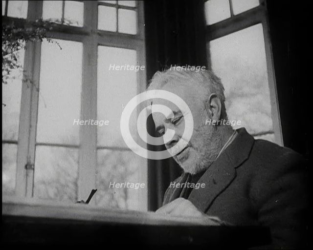 C.E.M Joad Sitting Down at His Desk, 1930s. Creator: British Pathe Ltd.