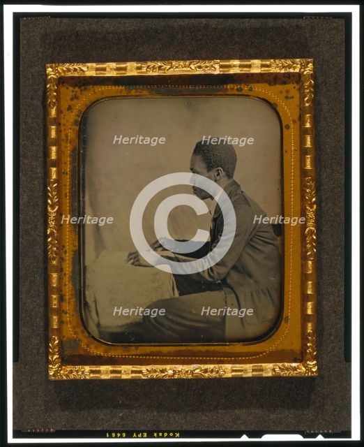 C.H. Hicks, in profile, seated at desk, between 1856 and 1858. Creator: Augustus Washington.