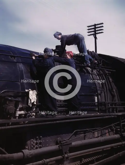 C. & N.W. R.R., women wipers at the roundhouse cleaning one of the giant..., Clinton, Iowa, 1943. Creator: Jack Delano.