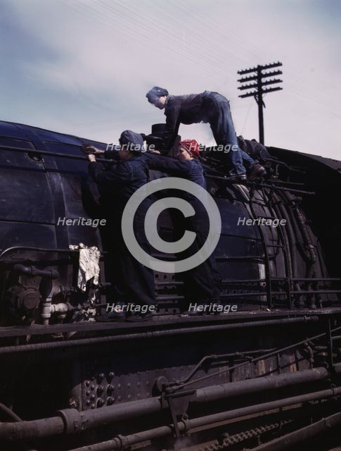 C. & N.W. R.R., women wipers at the roundhouse cleaning one of the giant..., Clinton, Iowa, 1943. Creator: Jack Delano.