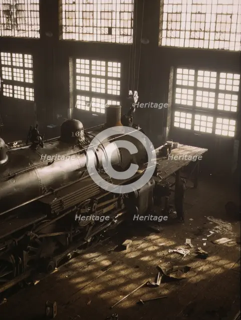 C & NW RR working on a locomotive at the 40th Street railroad shops, Chicago, Ill., 1942. Creator: Jack Delano.
