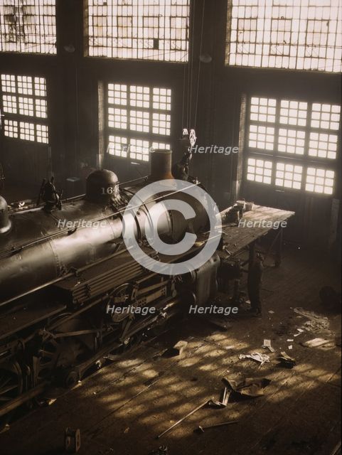 C & NW RR working on a locomotive at the 40th Street railroad shops, Chicago, Ill., 1942. Creator: Jack Delano.