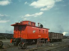 C & NW RR putting the finishing touches on a rebuilt caboose..., Proviso yard, Chicago, Ill., 1943. Creator: Jack Delano