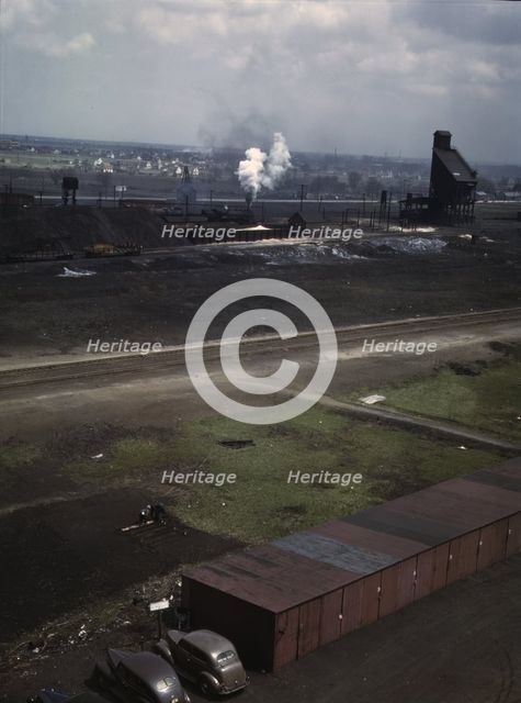C & NW RR railroad worker cultivating the small Victory garden, Proviso yard, Chicago, Ill., 1943. Creator: Jack Delano.
