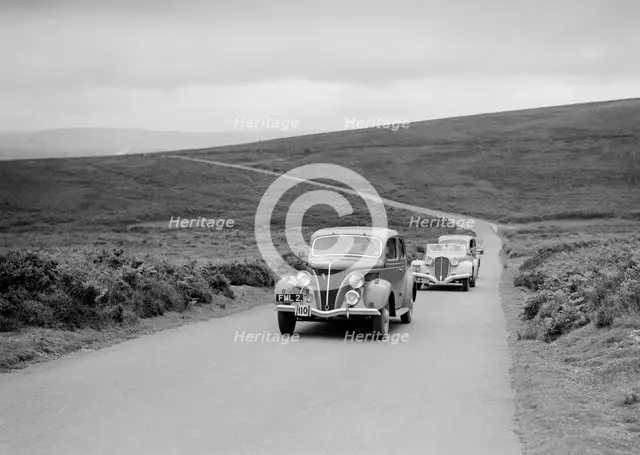 GM Denton's Ford V8 leading the Delahaye of DA Loader at the MCC Torquay Rally, July 1937. Artist: Bill Brunell.