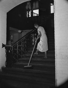 Government charwoman cleaning after regular working hours, Washington, D.C., 1942. Creator: Gordon Parks