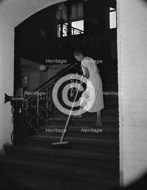 Government charwoman cleaning after regular working hours, Washington, D.C., 1942. Creator: Gordon Parks.