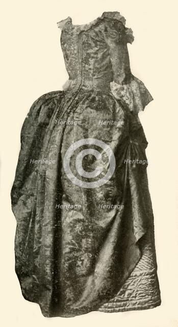 'Gown of yellow damask brocade worn over a blue quilted satin petticoat, c1710-1730, (1937). Creator: Unknown.