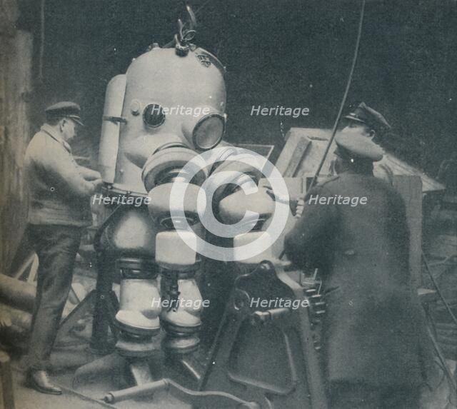 'Going Down at Short Notice: A British Diver Preparing To Seek a Submarine at Sea Bottom', c1935. Artist: Pacific and Atlantic.