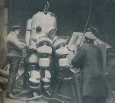 Going Down at Short Notice: A British Diver Preparing To Seek a Submarine at Sea Bottom c1935. Artist: Pacific and Atlantic