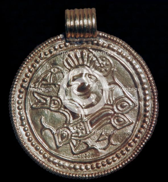 Gold bracteate from Sweden showing Odin and a raven. Artist: Unknown