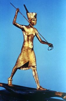 Gold figure of King Tutankhamun standing on a reed boat and spearing fish, 14th century BC