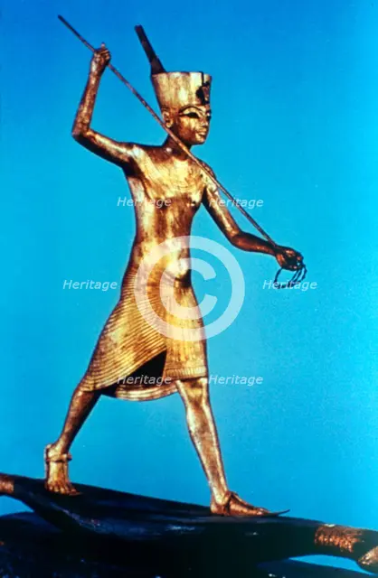 Gold figure of King Tutankhamun standing on a reed boat and spearing fish, 14th century BC. Artist: Unknown