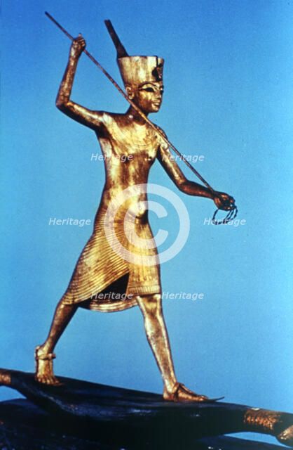 Gold figure of King Tutankhamun standing on a reed boat and spearing fish, 14th century BC. Artist: Unknown
