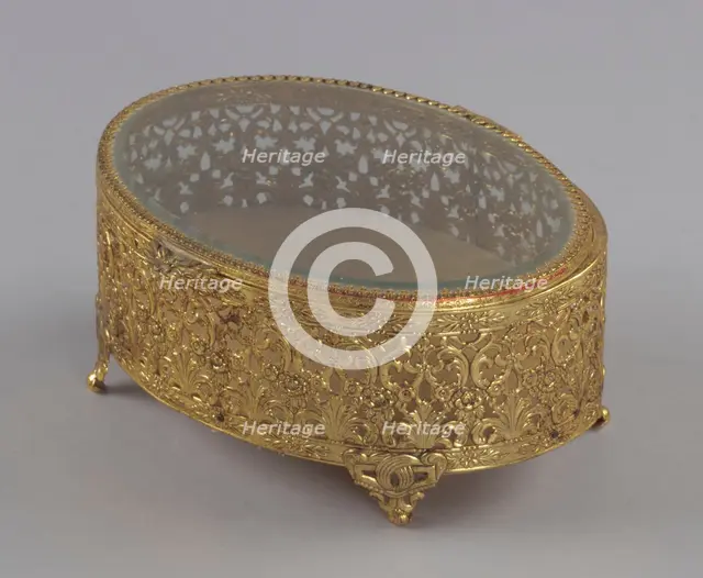 Gold metal scrollwork jewelry box from Mae's Millinery Shop, 1941-1994. Creator: Unknown.