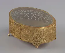 Gold metal scrollwork jewelry box from Mae's Millinery Shop, 1941-1994. Creator: Unknown