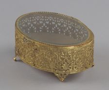 Gold metal scrollwork jewelry box from Mae's Millinery Shop, 1941-1994. Creator: Unknown